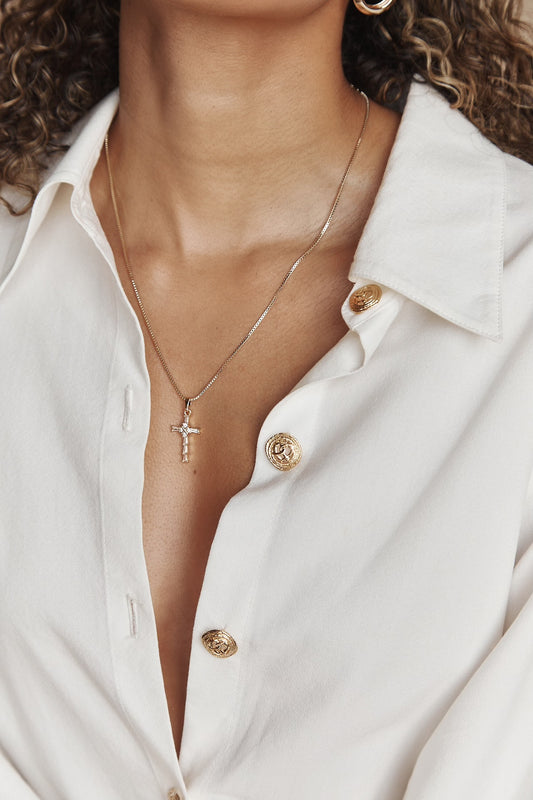 Gold vermeil cross pendant necklace styled on model