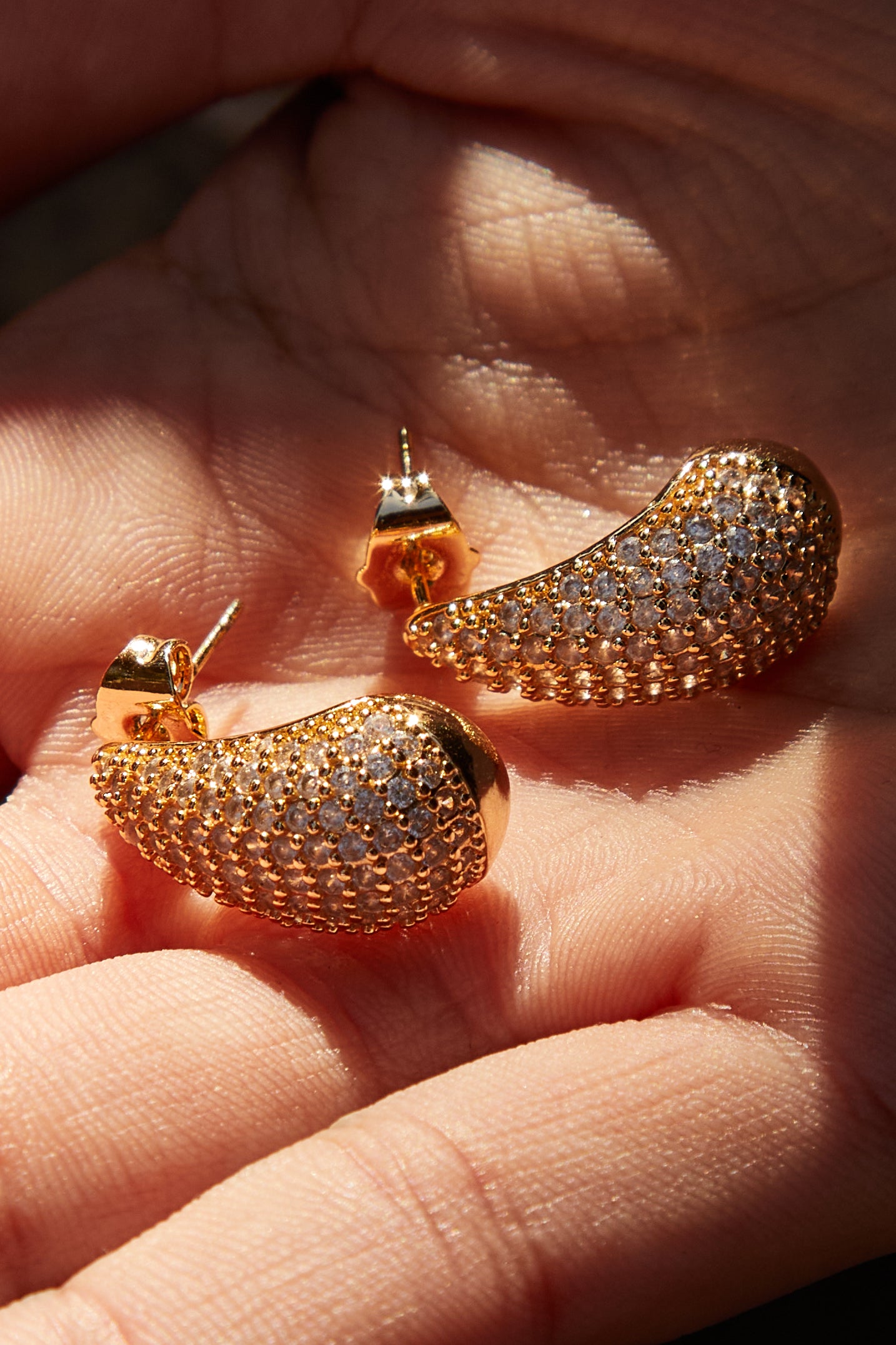 Gold-filled teardrop earrings on model with CZ stones